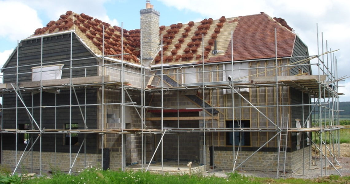 House under construction tiling roof