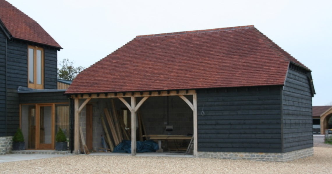 New garage with larch cladding and red tile roof